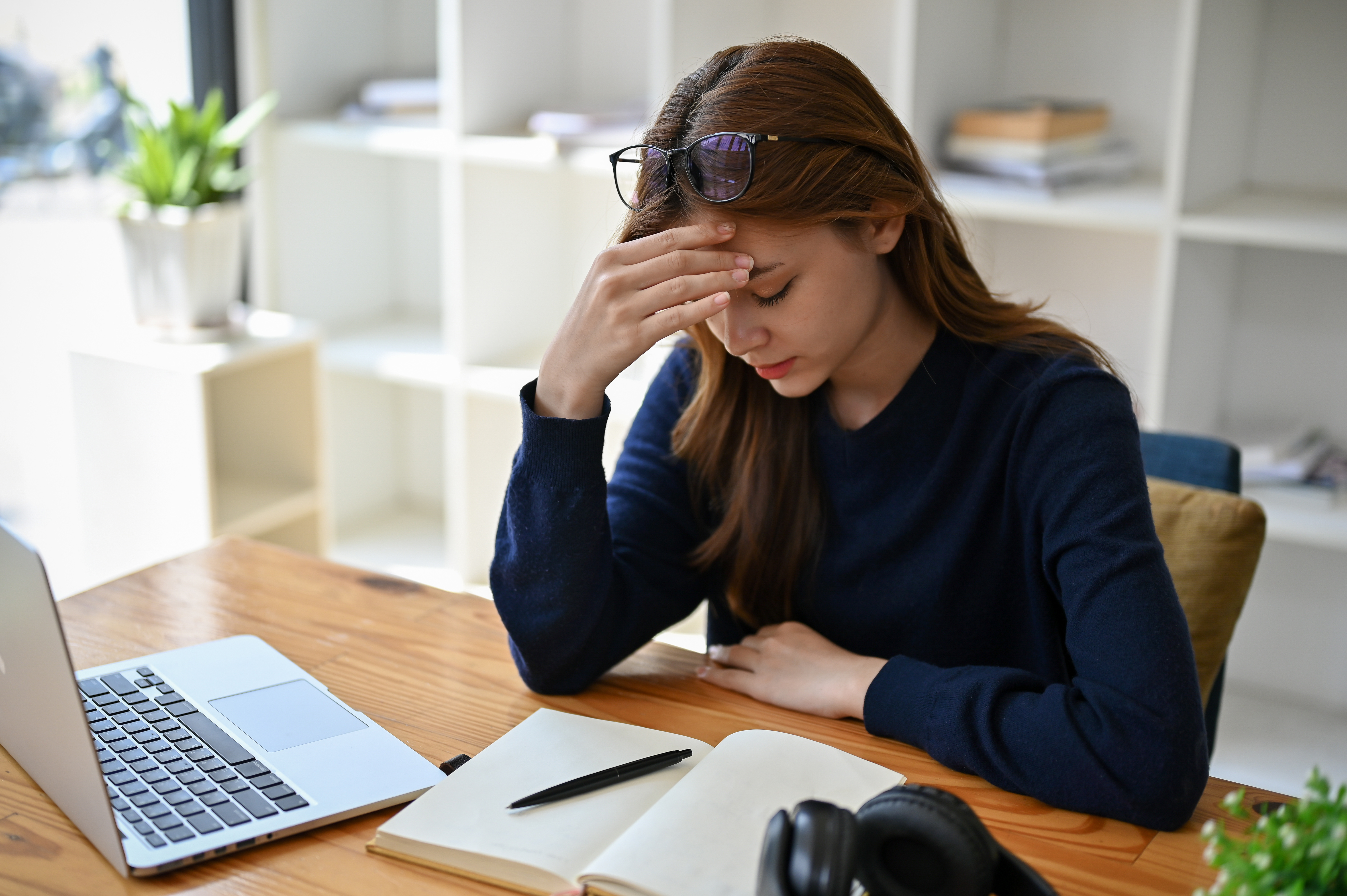 A stressed, anxious Asian businesswoman worried about the project's deadline